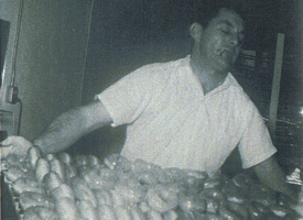 Man making Paradise Donuts, historic